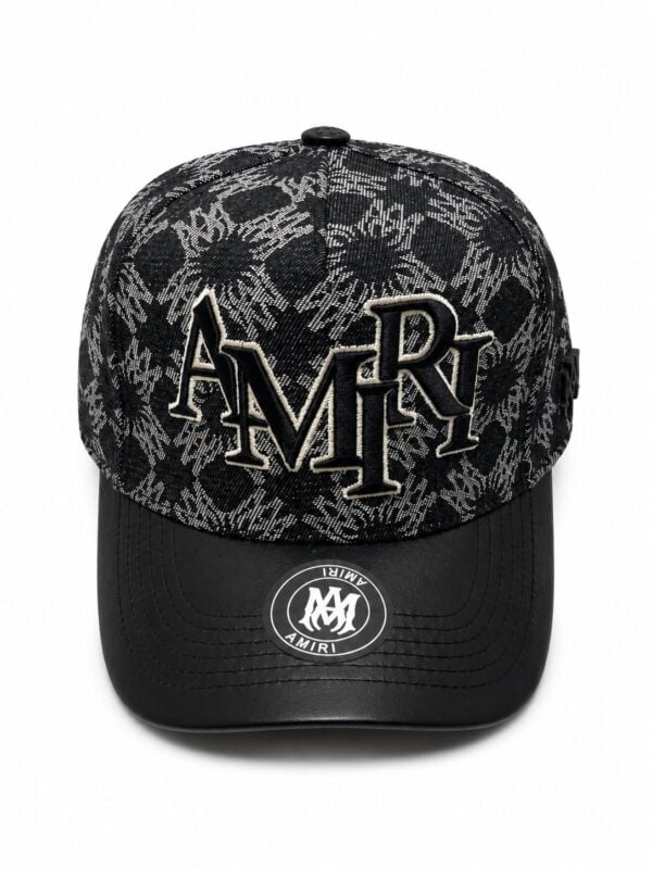 Stylish black monogram cap featuring embroidered "AMIRI" logo and abstract pattern, perfect for spor.