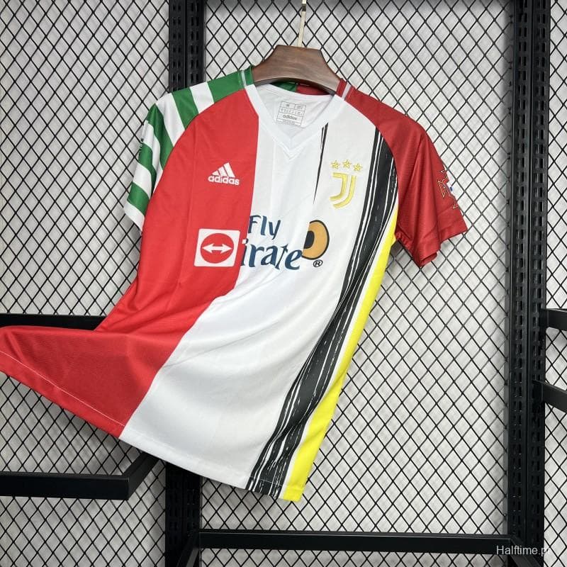 16c40444f867bb73 | UAE SPORT STORE Juventus Adidas jersey on a hanger against a metal grid, featuring red, white, and black panels with yellow accent and Fly Emirates sponsor logo on the chest.