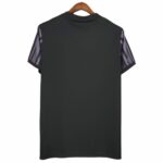 Back view of a dark gray short-sleeve shirt on a wooden hanger; sleeves have purple and black striped pattern.