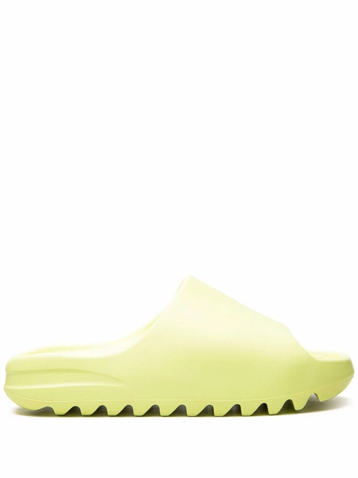 Lime-green rubber clog shown from the side with a thick, jagged sole and wavy tread pattern.