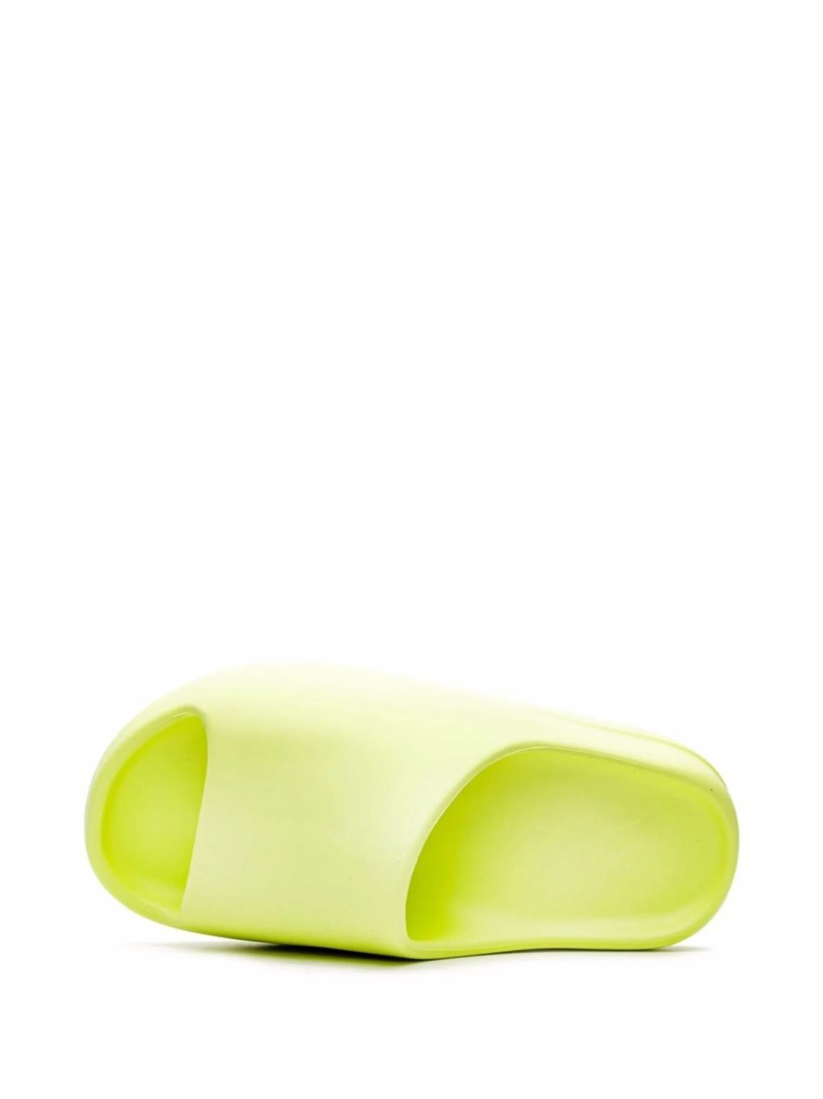 Close-up of a bright lime-green curved silicone object with two large oval openings, viewed from the side.