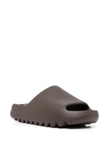 Brown slip-on platform sandal with a thick, ridged sole and cutout strap, shown from the side.