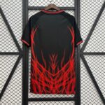 Black jacket with bright red flame graphic hanging on a wooden hanger against a metal mesh background