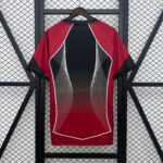 Red jacket with black central panel and white piping on a wooden hanger against a metal lattice backdrop, framed by dark shelving bars.