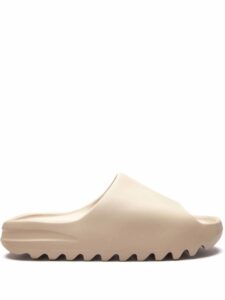 Beige platform sandal with a contoured footbed and a grooved, jagged outsole seen from the side