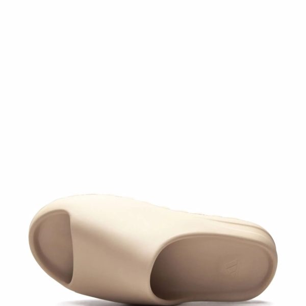 Beige prosthetic foot shell viewed from the side, showing a curved, hollowed underside and toe area designed to fit a residual limb.