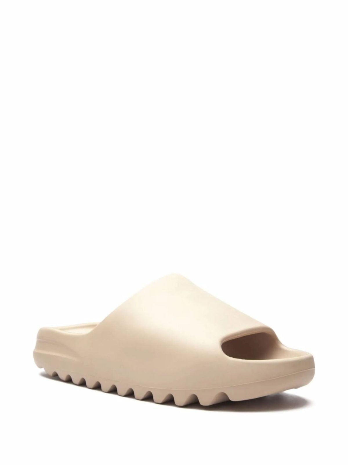 Beige slip-on clog-style shoe with a chunky sole on a white background, shown from a side perspective at the toe area.