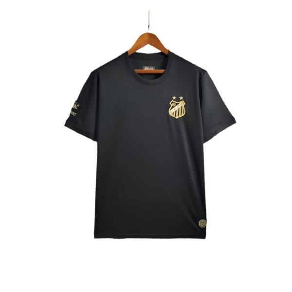 Black short-sleeve T-shirt on a wooden hanger with a gold crest logo on the left chest and two small stars above it.