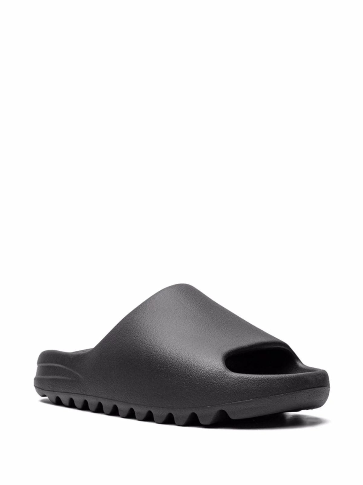 Black slide sandal with a closed-toe style, shown from the side on a white background.