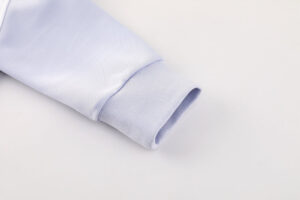 181977ee | UAE SPORT STORE Close-up of a light blue dress shirt sleeve with a ribbed cuff folded at the end