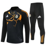 Black Real Madrid training jacket and pants set with orange crack pattern and crest, Adidas logo visible on chest and leg.
