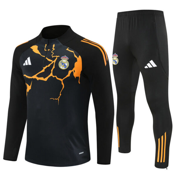 Black Real Madrid training jacket and pants set with orange crack pattern and crest, Adidas logo visible on chest and leg.