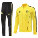 Yellow Borussia Dortmund track jacket with black piping and star crest, paired with black pants featuring gold side stripe and club logos