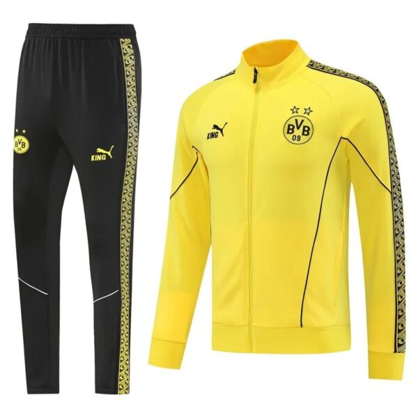 Yellow Borussia Dortmund track jacket with black piping and star crest, paired with black pants featuring gold side stripe and club logos