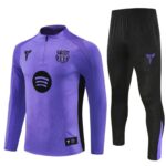 Purple long-sleeve training jersey with a crest and Spotify logo, paired with black athletic pants on the right.
