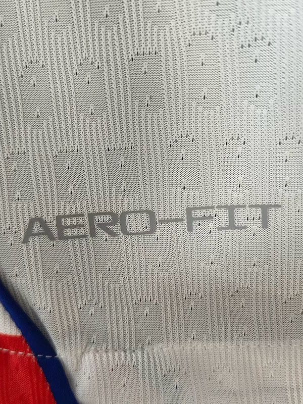 18e9d894-35ed-4af2-9681-8cf0ab3308f6 | UAE SPORT STORE Close-up of gray textured fabric with the brand name 'AERO-FIT' printed on it.