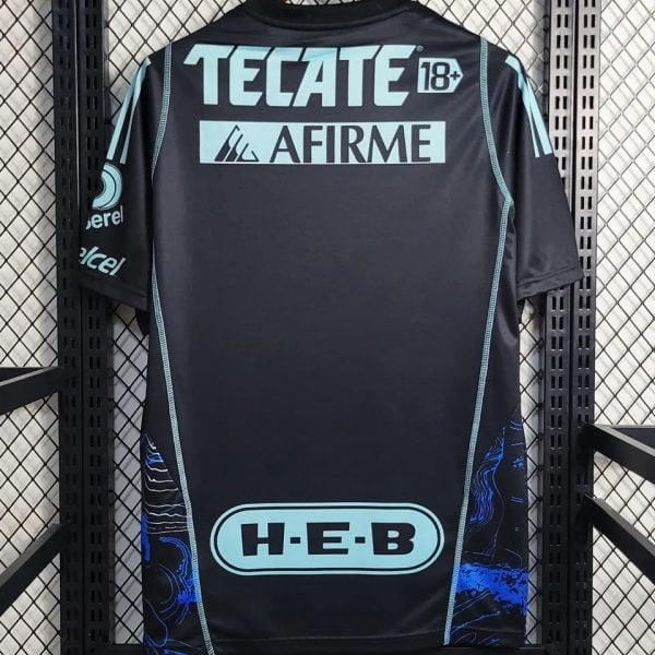 Back view of a dark sports jersey with light blue sponsor logos: TECATE 18+, AFIRME, H-E-B, and side details in blue.