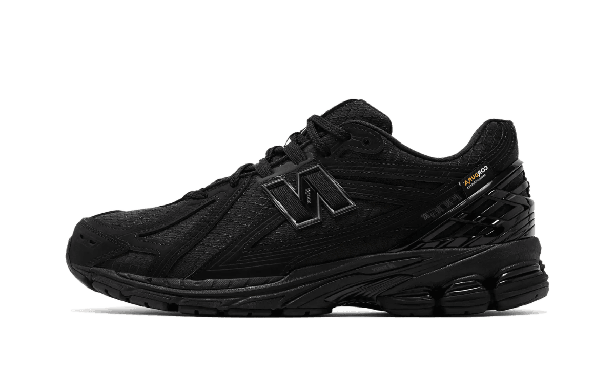 Black athletic sneaker with a chunky sole and stitched overlays, viewed from the side.