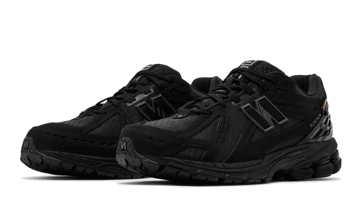 Pair of black athletic sneakers with chunky sole and textured upper, shown from a side angle on a white background