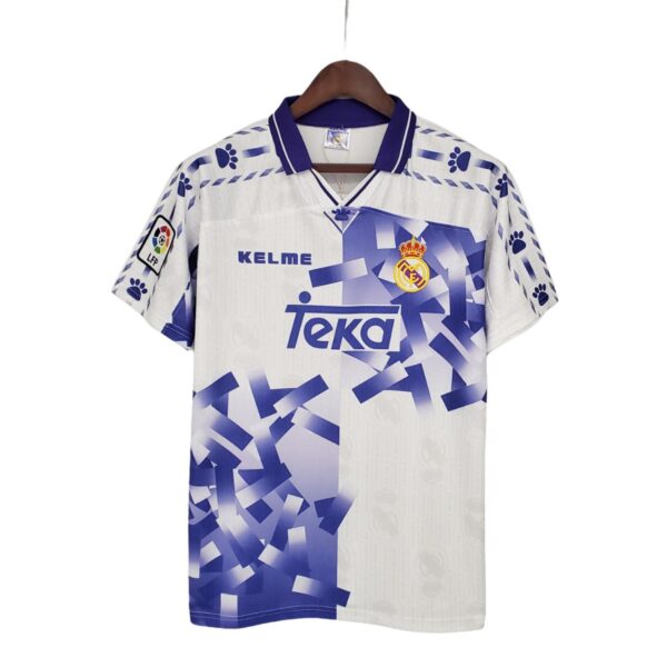 Real Madrid football jersey on a hanger with Teka sponsor and club crest.