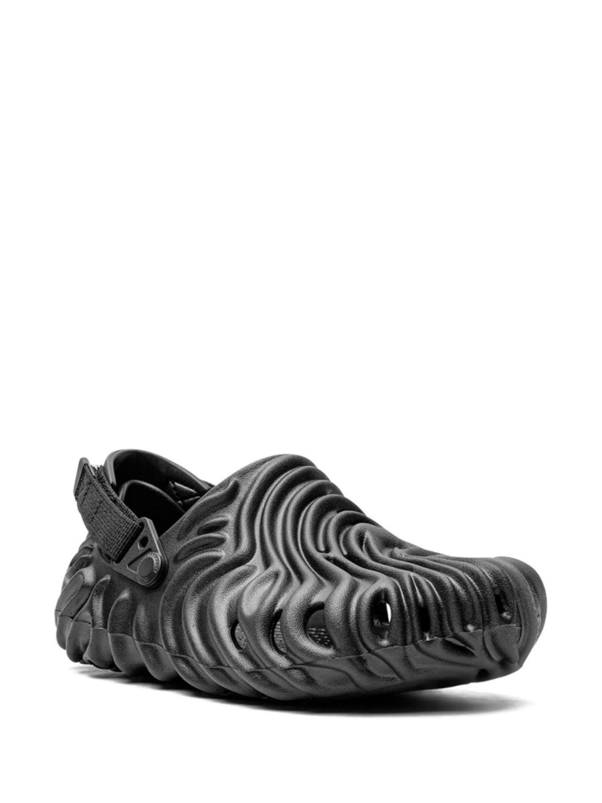 Close-up of a black athletic sneaker with a thick, wavy-ridged sole and a heel strap detail.