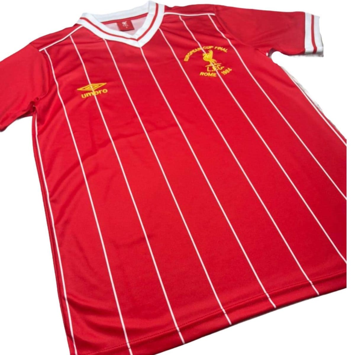 Red striped soccer jersey with white pinstripes and a white collar, featuring a yellow Umbro logo on the left chest and a Liverpool crest on the right chest.
