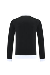 Back view of a black long-sleeve top with white cuffs and a white hem.