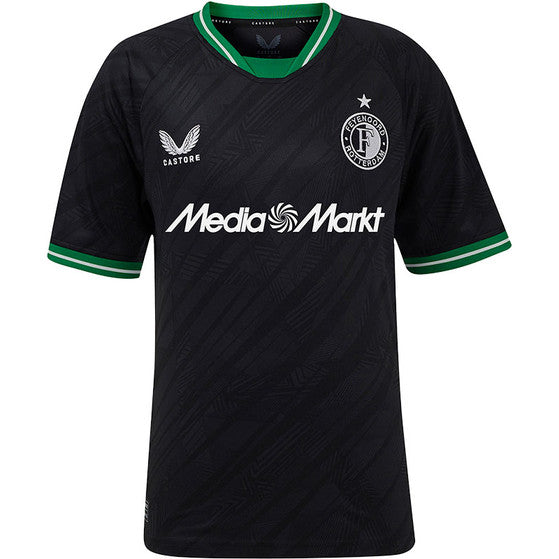 Black soccer jersey with green trim, featuring a club crest, Castore logo, and the MediaMarkt sponsor text on the chest.