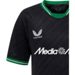 196694_2_1 | UAE SPORT STORE Black football jersey with green collar and cuffs, Castore logo on chest and 'Media' sponsor across front.