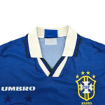 Blue Brazil national team jersey with white collar and CBF crest on the chest.