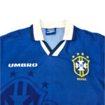 Brazil national football team blue jersey with CBF crest, Umbro logo, and white collar detail, worn by Brazil.
