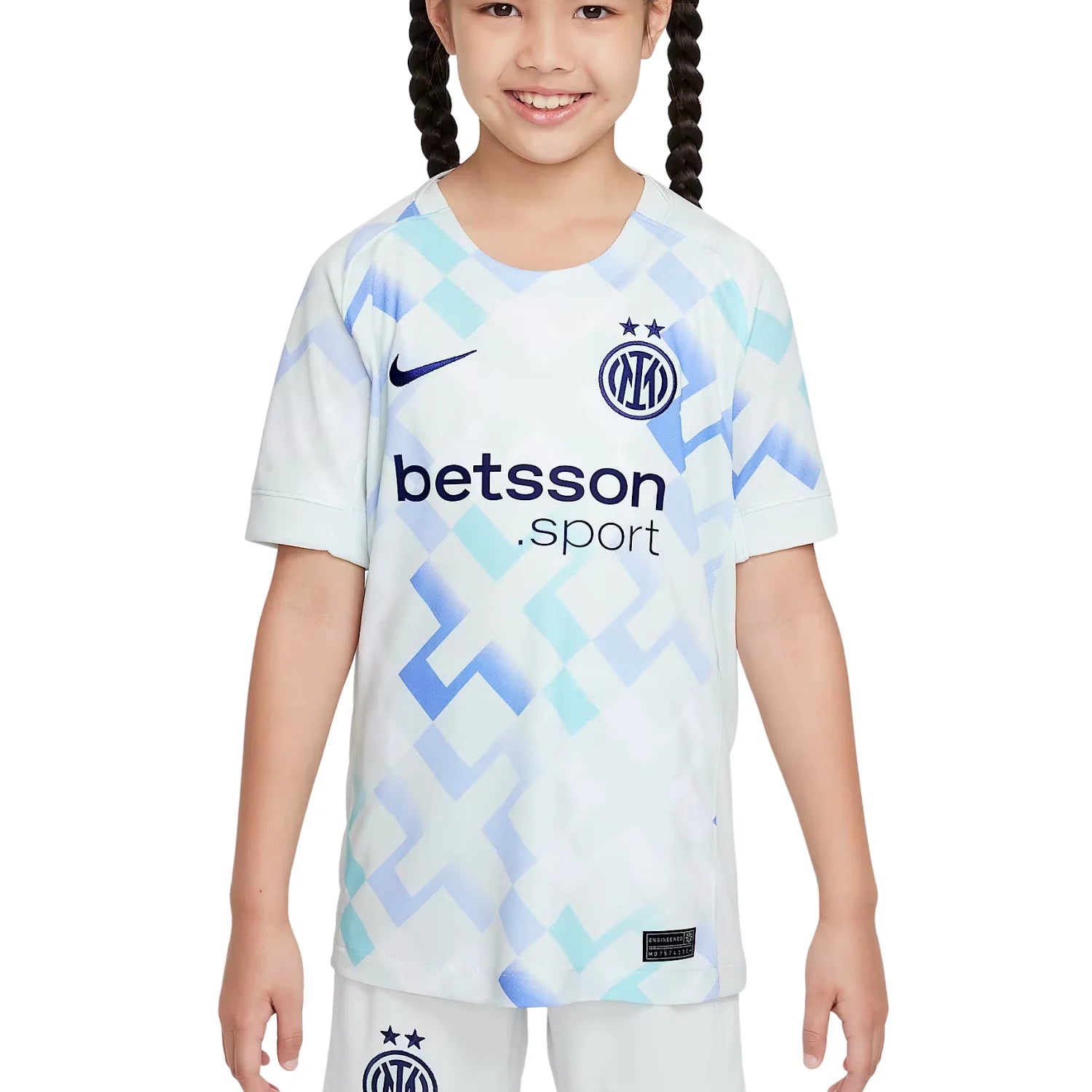 19_c94048ed-a429-4e6a-9743-fa712555976b_1 | UAE SPORT STORE Young girl wearing an Inter Milan kids' football jersey with a geometric white-and-blue pattern, crest, and Betsson sponsor logo on the front.