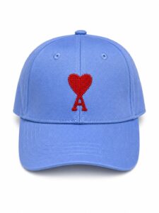 Blue baseball cap with red embroidered heart-and-ribbon design on the front.