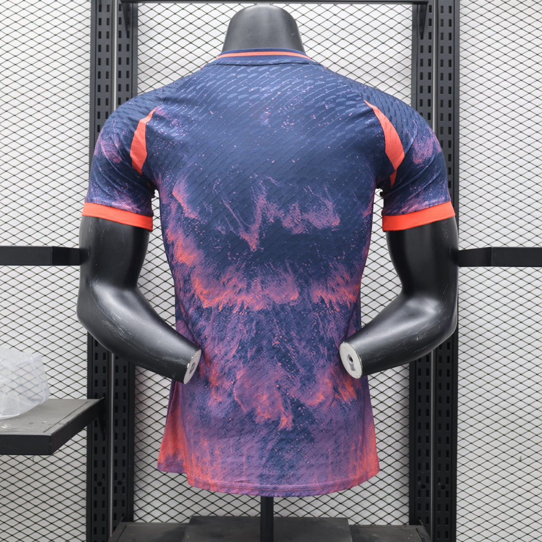19bd88d8 | UAE SPORT STORE Back view of a tie-dye purple and pink athletic shirt with orange trim on sleeves, displayed on a mannequin in a rack.