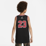 Back view of a child wearing a black basketball jersey with red-outlined number 23 and a white Jumpman logo on the upper back.