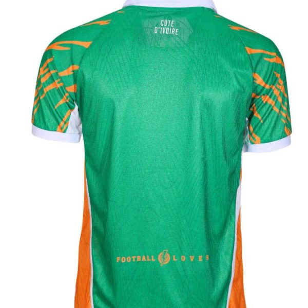 Back view of a green football jersey with orange side panels, white collar and cuffs; 'Côte d'Ivoire' at the neck and a 'Football Lover' logo near the hem.