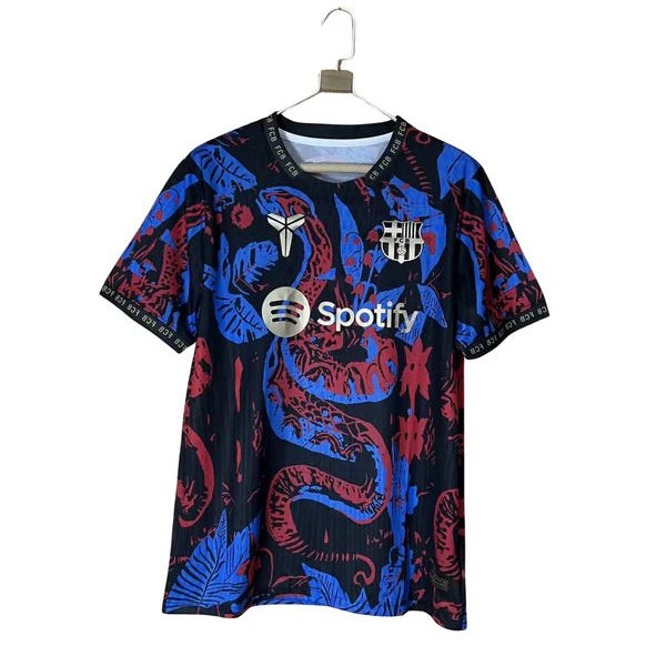 Dark blue football jersey with red and blue serpentine pattern, Spotify sponsor logo, and FC Barcelona crest on the chest, hanging on a hanger.