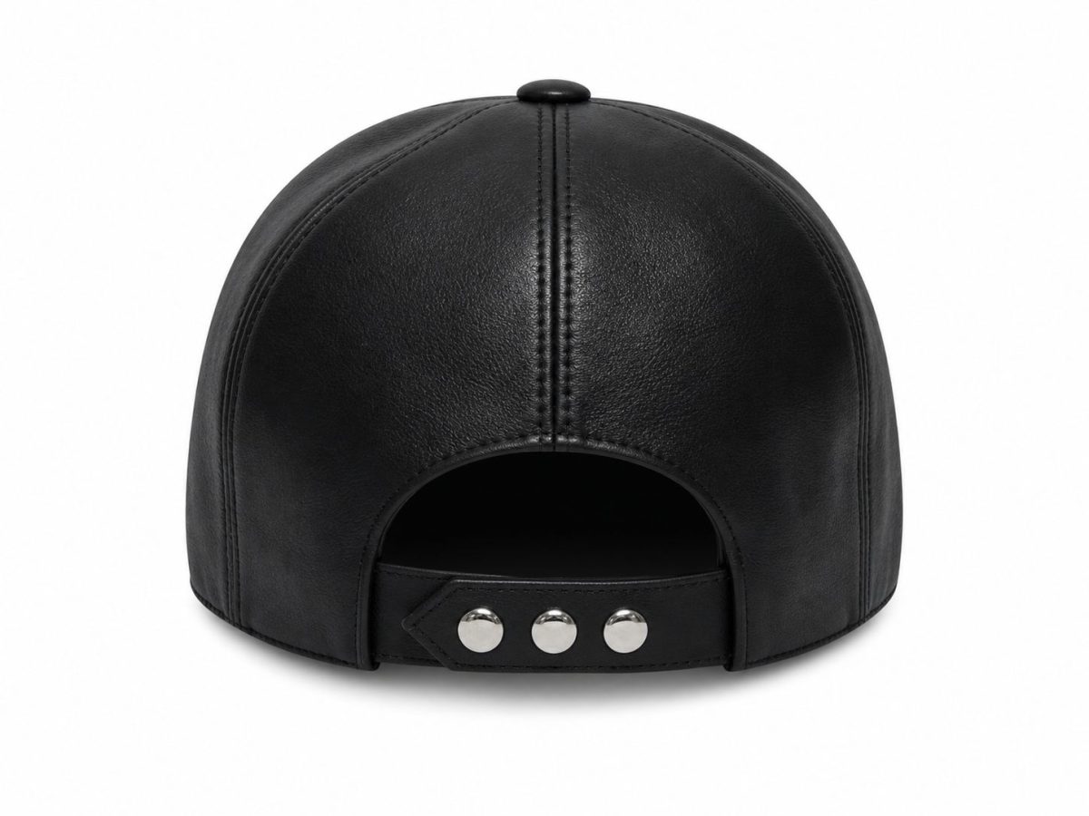 Rear view of a black leather cap with an adjustable strap and silver snap buttons on a white background