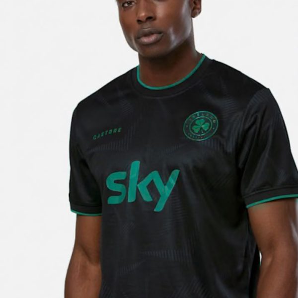 Adult man wearing a black Celtic football jersey with green trim and a prominent 'sky' logo, facing the camera.