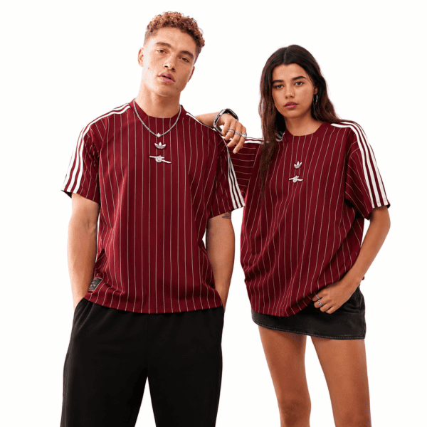 1c384221-3aed-49d1-83cb-db8d9dc966ee - UAE SPORT STORE Two models wear maroon Arsenal jerseys with white pinstripes, season 2025/26.