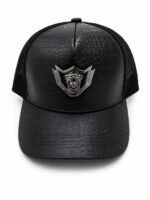 Black leather-look crown cap with lion emblem.