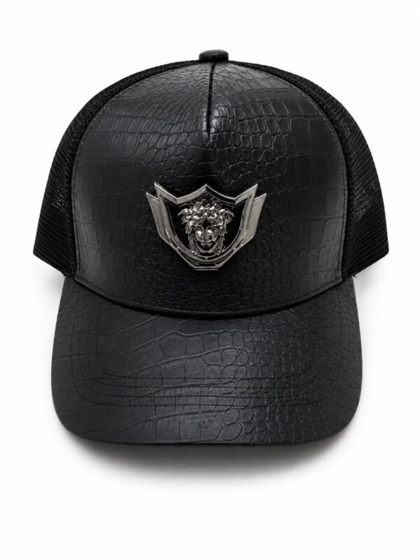 Black leather-look crown cap with lion emblem.