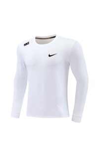 White Nike athletic long-sleeve shirt on a mannequin, showing a black Nike swoosh logo and small Nike text on the shoulder edge.