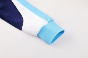 1fc42c85 | UAE SPORT STORE Close-up of a color-blocked sleeve with a light blue cuff, white middle panel, and navy stripe at the top edge.