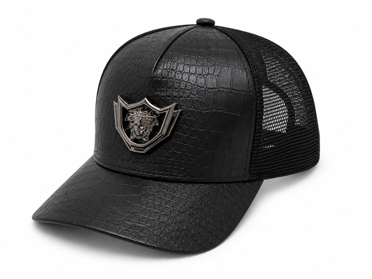 Black trucker cap with a faux crocodile-embossed front and a silver lion crest badge on the front panel, plus a mesh back.