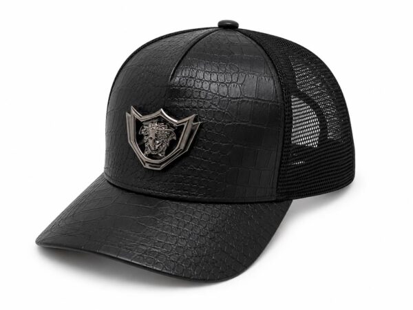 Black leather-look crown cap with metallic emblem.