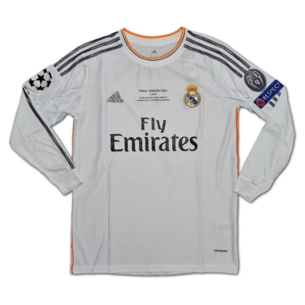 White Real Madrid goalkeeper jersey with orange trim, Adidas stripes, and 'Fly Emirates' sponsor logo onscreen.