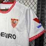 White sports jersey on hanger with red zigzag collar trim, club crest on the chest, and 'DEGIRO' sponsor across the front.