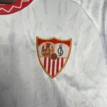 Close-up of a white jersey showing the Sevilla FC crest on the chest