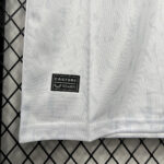 Close-up of white fabric with a black Castore brand label and serial number near the hem.